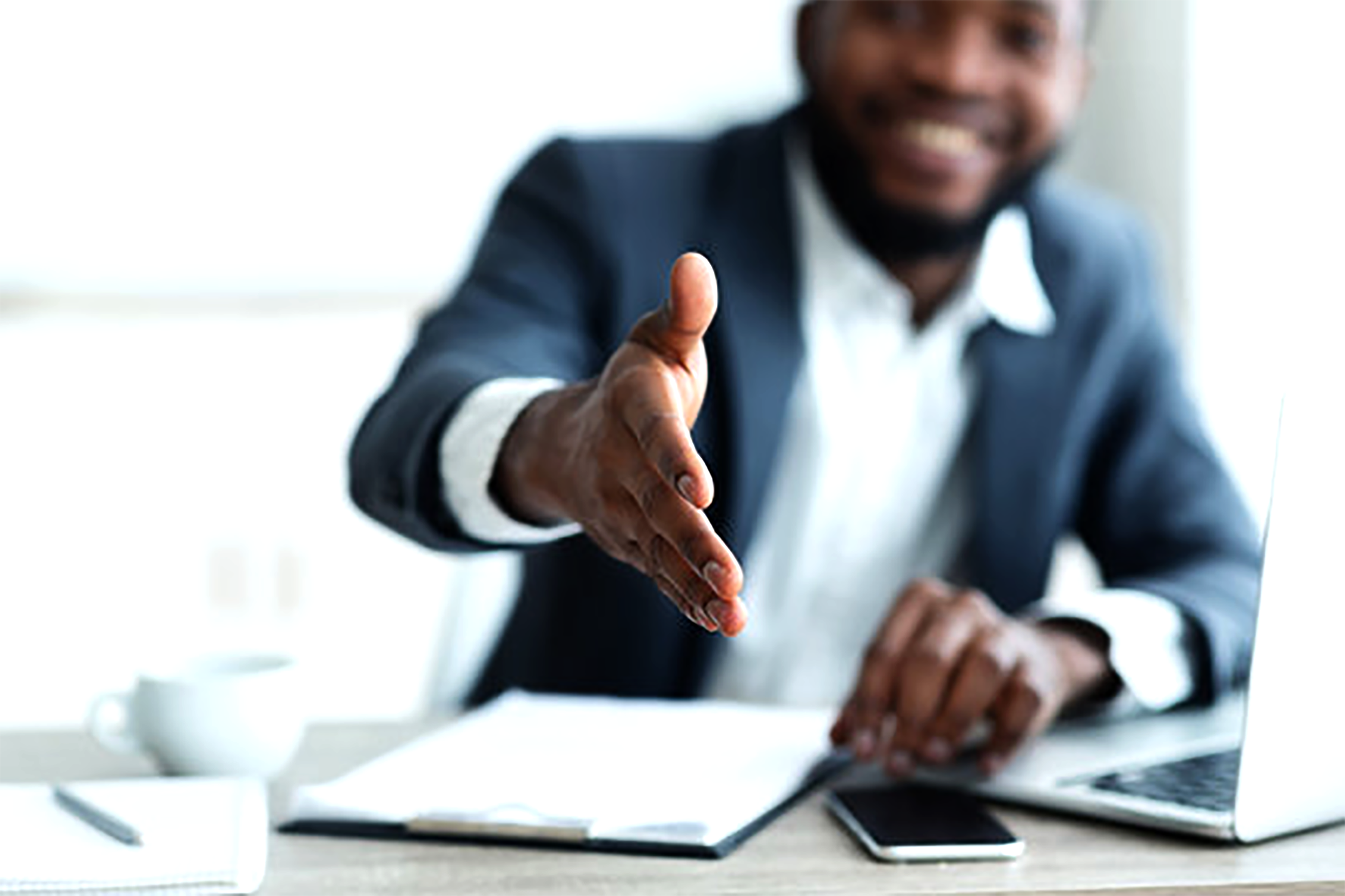 Business consultant extending hand for a handshake